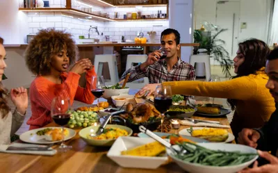 Friends sharing a home-cooked dinner around a kitchen table